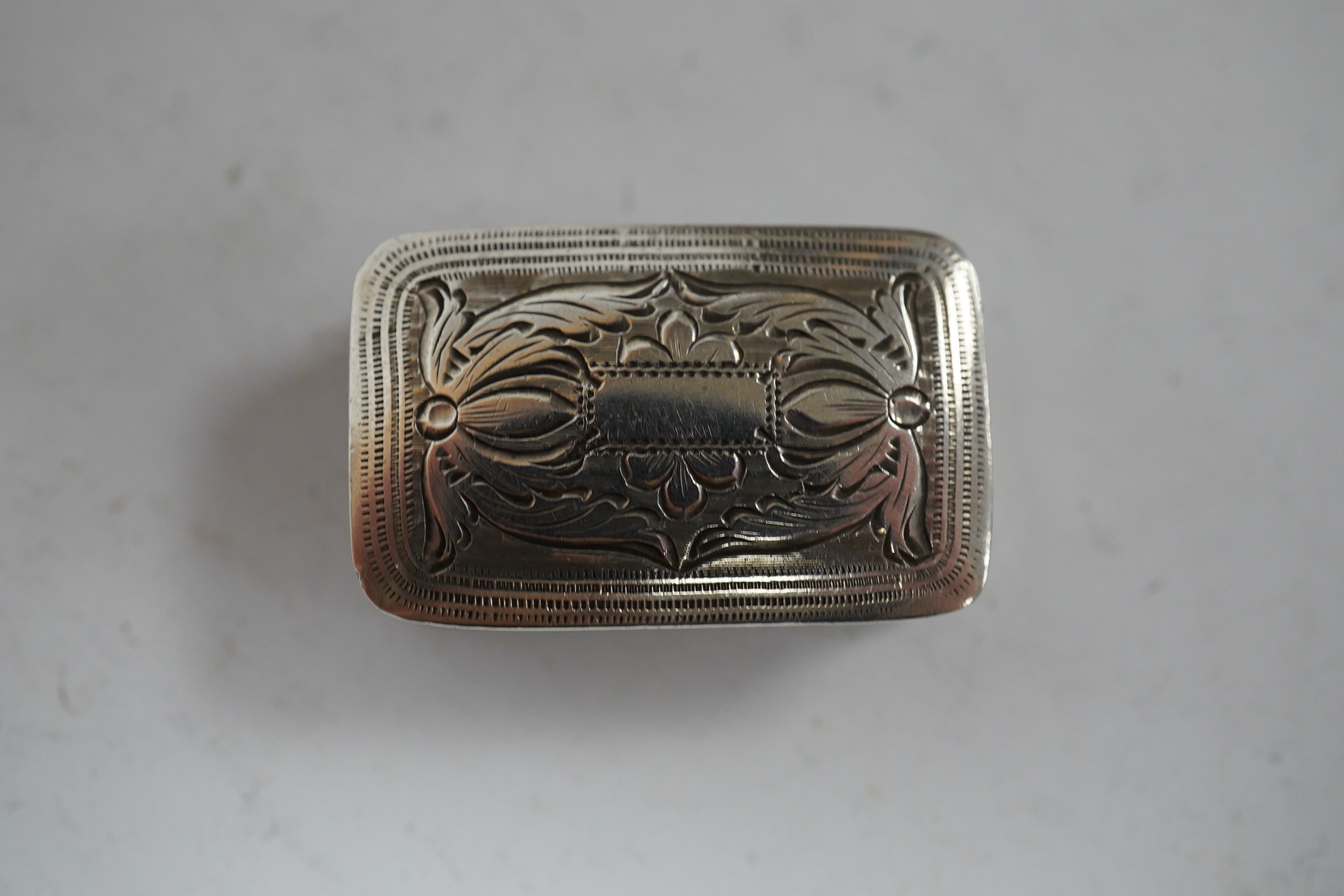 A George IV engraved silver rectangular vinaigrette, Joseph Wilmore, Birmingham, 1829, 26mm. Condition - fair to good